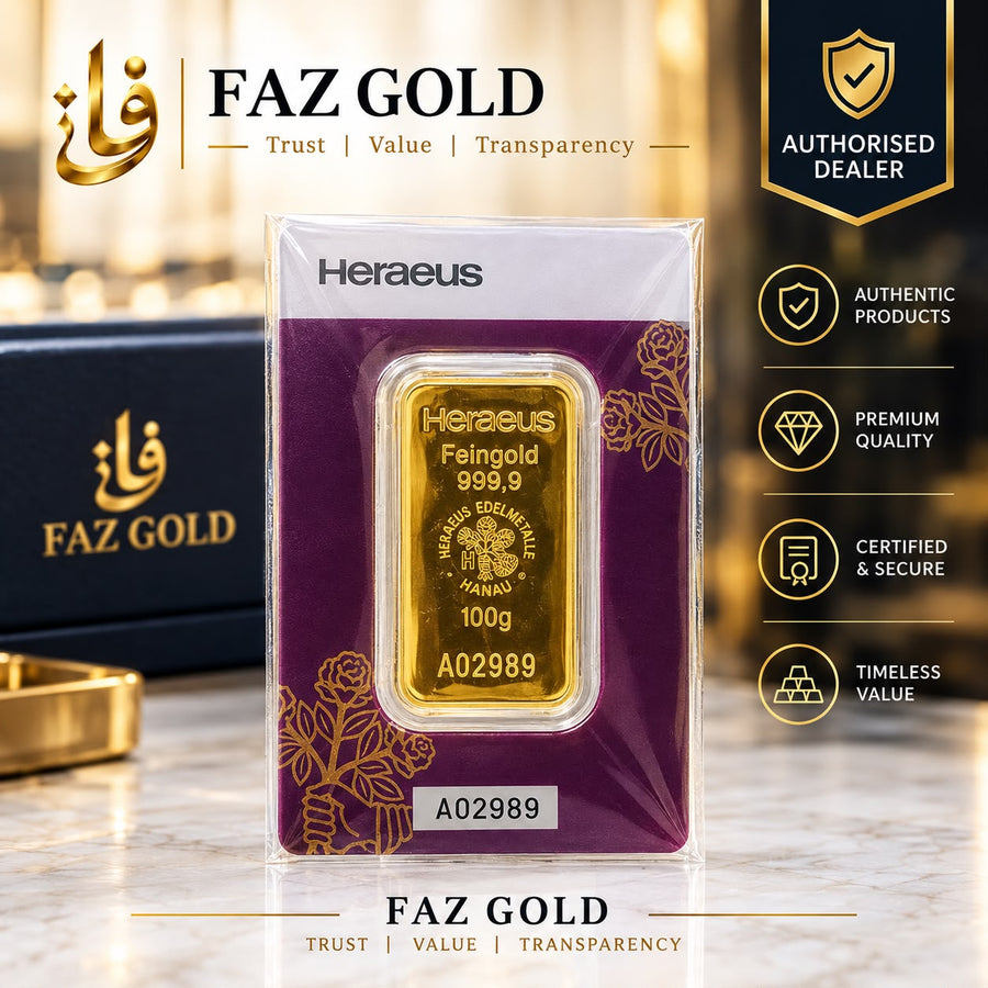 Heraeus 100g fine gold bar 999.9 sealed in tamper-evident assay packaging, on a FAZ GOLD authorised dealer display card
