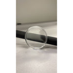 Empty clear acrylic coin capsule standing on edge, sized for a 1 oz silver coin