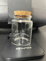 Empty 60ml clear glass savings bottle with cork stopper, showing its actual size and finish