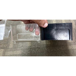 Hand holding the PAMP storage box with the clear drawer partly pulled out of its black outer case