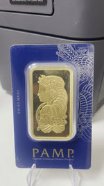 PAMP Suisse 100g gold bar showing the Lady Fortuna design in its sealed blue Veriscan assay card