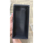 Inside the PAMP storage box showing the ribbed slots that hold individual assay-card gold bars upright