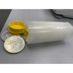 Translucent coin tube lying on its side with the yellow cap off and silver coins alongside for scale